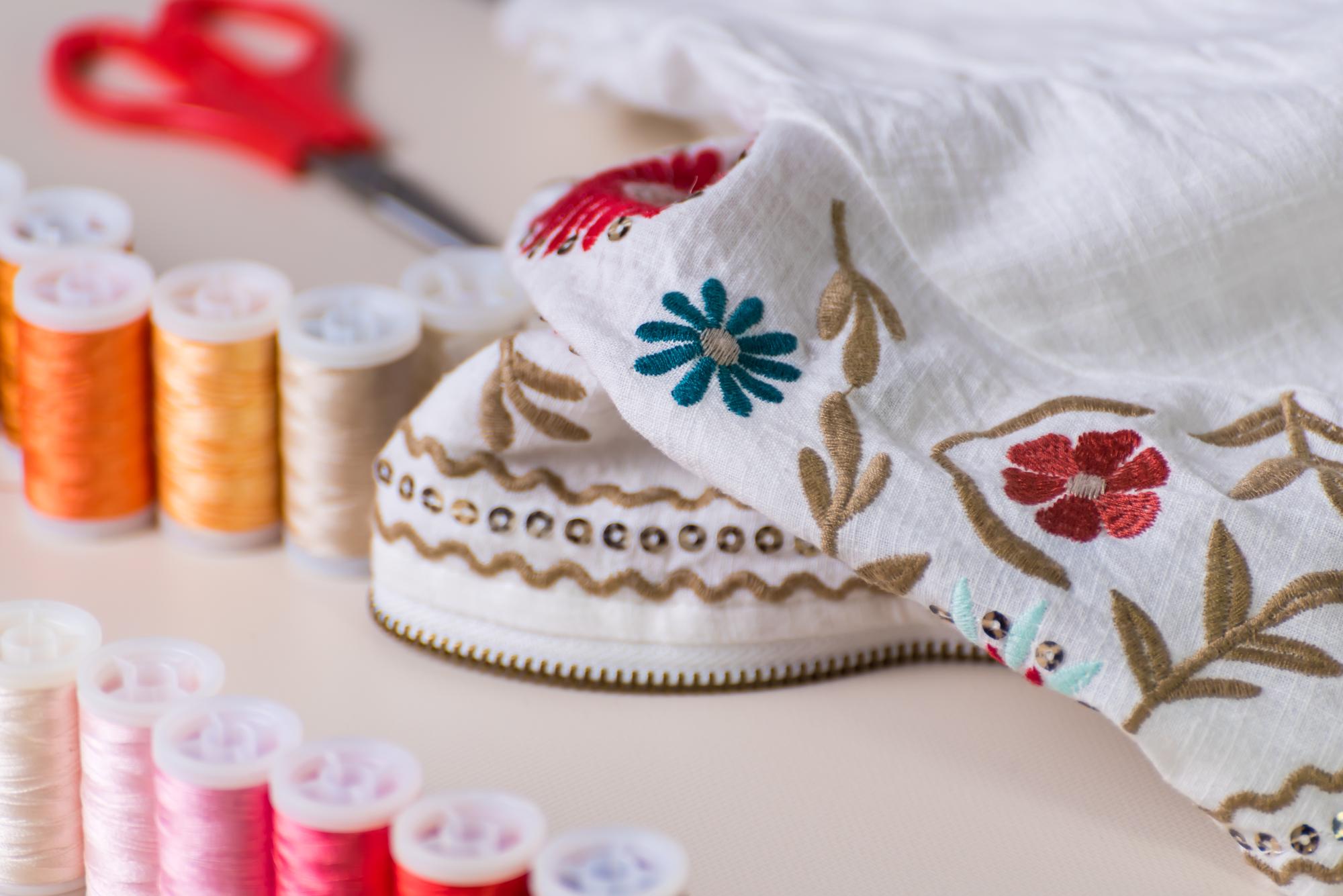 artisan stitching at studio table